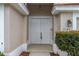 Close-up of the double front doors and an arched entryway at 9149 Penelope Dr, Weeki Wachee, FL 34613