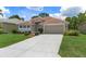 Single-story home featuring well-maintained landscaping and a spacious driveway at 9149 Penelope Dr, Weeki Wachee, FL 34613