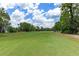 Expansive green golf course with lush fairway and blue sky at 9149 Penelope Dr, Weeki Wachee, FL 34613