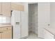 Kitchen features white refrigerator and a large walk in pantry at 9149 Penelope Dr, Weeki Wachee, FL 34613