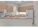 Bright kitchen featuring wood cabinets, modern appliances, and a breakfast bar at 9149 Penelope Dr, Weeki Wachee, FL 34613