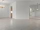 Open concept living room with neutral tile flooring and views into other rooms at 9149 Penelope Dr, Weeki Wachee, FL 34613