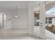 Bright open floor plan with tile flooring, French doors, and outdoor views at 9149 Penelope Dr, Weeki Wachee, FL 34613