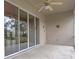 A covered patio featuring tiled flooring, a ceiling fan, and sliding glass doors at 9149 Penelope Dr, Weeki Wachee, FL 34613