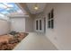 A screened-in patio area with a tranquil rock garden view and ceiling fan at 9149 Penelope Dr, Weeki Wachee, FL 34613