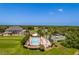 Aerial view of the community pool, golf course, and tennis court surrounded by lush landscaping at 9406 Burnam Dr, Weeki Wachee, FL 34613