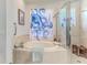 Luxury bathroom with standalone tub, glass shower, and octopus-themed shower curtain at 9406 Burnam Dr, Weeki Wachee, FL 34613