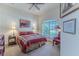 Cozy bedroom with colorful bedding and a large window overlooking the backyard at 9406 Burnam Dr, Weeki Wachee, FL 34613