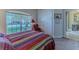 Cozy bedroom with large window, closet and colorful quilt at 9406 Burnam Dr, Weeki Wachee, FL 34613