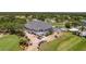 Aerial view of the GlenLakes clubhouse, golf course, and parking area at 9406 Burnam Dr, Weeki Wachee, FL 34613