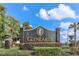 Beautiful GlenLakes community sign surrounded by lush landscaping and palm trees at 9406 Burnam Dr, Weeki Wachee, FL 34613
