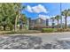 Elegant GlenLakes community sign surrounded by lush landscaping and palm trees at 9406 Burnam Dr, Weeki Wachee, FL 34613