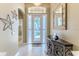 Inviting foyer featuring a decorative glass front door, tiled floor, and modern decor at 9406 Burnam Dr, Weeki Wachee, FL 34613