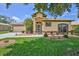 Inviting single-story home featuring a well-maintained lawn and colorful landscaping at 9406 Burnam Dr, Weeki Wachee, FL 34613