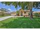 Charming single-story home featuring a well-maintained lawn and mature shade tree at 9406 Burnam Dr, Weeki Wachee, FL 34613