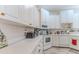 Bright kitchen with white cabinets, light countertops, and updated appliances at 9406 Burnam Dr, Weeki Wachee, FL 34613