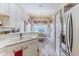 Kitchen featuring a dining area, white counters and cabinets, and stainless steel appliances at 9406 Burnam Dr, Weeki Wachee, FL 34613