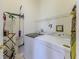 Laundry room with modern washer and dryer and storage at 9406 Burnam Dr, Weeki Wachee, FL 34613