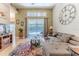 Comfortable living room with a large window, neutral decor, and access to the pool area at 9406 Burnam Dr, Weeki Wachee, FL 34613