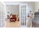 Cozy living room with red armchairs, wood furniture, and view into bedroom at 9406 Burnam Dr, Weeki Wachee, FL 34613