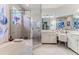 Elegant main bathroom with a glass-enclosed shower and tub, plus double sink vanity at 9406 Burnam Dr, Weeki Wachee, FL 34613