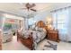 Spacious main bedroom with ceiling fan, natural lighting, and pool views at 9406 Burnam Dr, Weeki Wachee, FL 34613