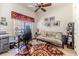 Bright home office with a ceiling fan, large window, and neutral-toned carpet at 9406 Burnam Dr, Weeki Wachee, FL 34613