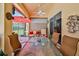 Inviting covered patio with stylish seating, ceiling fan, and sliding glass doors to the yard at 9406 Burnam Dr, Weeki Wachee, FL 34613