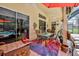 Outdoor patio with colorful rug and comfortable seating next to pool at 9406 Burnam Dr, Weeki Wachee, FL 34613