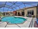 Pool with screened enclosure, patio, grill and lounging area at 9406 Burnam Dr, Weeki Wachee, FL 34613