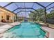 Screened-in pool with patio and a sunny backyard at 9406 Burnam Dr, Weeki Wachee, FL 34613