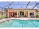 Enclosed pool with an expansive patio, lounge chairs and grilling area at 9406 Burnam Dr, Weeki Wachee, FL 34613