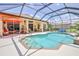 A screened-in pool with a spacious patio and outdoor furniture at 9406 Burnam Dr, Weeki Wachee, FL 34613