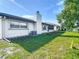 Backyard of the house with a chimney and air conditioning unit at 9425 Sterling Ln, Port Richey, FL 34668