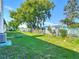 A well-kept backyard offers outdoor space with lush green grass, landscaping, and a chainlink fence at 9425 Sterling Ln, Port Richey, FL 34668
