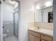 Practical bathroom with tiled shower, neutral vanity, and ample lighting at 9425 Sterling Ln, Port Richey, FL 34668