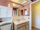 Cozy bathroom with mirrored vanity, cabinet storage, and neutral tones at 9425 Sterling Ln, Port Richey, FL 34668