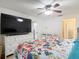 Bright bedroom featuring a TV, and en suite bathroom, offering comfort at 9425 Sterling Ln, Port Richey, FL 34668