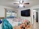 Comfortable bedroom with access to an outdoor patio, featuring a large dresser and floral bedding at 9425 Sterling Ln, Port Richey, FL 34668