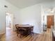 Cozy dining area adjacent to the kitchen and entryway features wood-look flooring at 9425 Sterling Ln, Port Richey, FL 34668