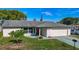 A well-maintained single-story home with a lush front yard and two-car garage at 9425 Sterling Ln, Port Richey, FL 34668