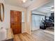 Bright foyer with decorative wood door leading to a home office and living spaces at 9425 Sterling Ln, Port Richey, FL 34668