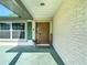 Inviting front entrance with a decorative wood door, sidelight, and brick facade at 9425 Sterling Ln, Port Richey, FL 34668