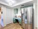 Bright kitchen offering stainless steel refrigerator, shaker cabinets, and pantry access at 9425 Sterling Ln, Port Richey, FL 34668