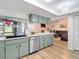 Modern kitchen featuring updated stainless steel dishwasher and an open concept design at 9425 Sterling Ln, Port Richey, FL 34668