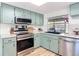 Updated kitchen featuring shaker cabinets and stainless steel dishwasher and sink at 9425 Sterling Ln, Port Richey, FL 34668