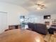 Open-concept design connects dining area to the living room with brick fireplace at 9425 Sterling Ln, Port Richey, FL 34668