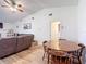 Open-concept living room and dining area boasts vaulted ceilings and neutral decor at 9425 Sterling Ln, Port Richey, FL 34668