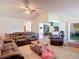 Spacious living room showcasing an open floor plan, natural light, and seamless flow to the kitchen at 9425 Sterling Ln, Port Richey, FL 34668