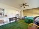 A sunroom with green carpet, many windows, and a hot tub at 9425 Sterling Ln, Port Richey, FL 34668
